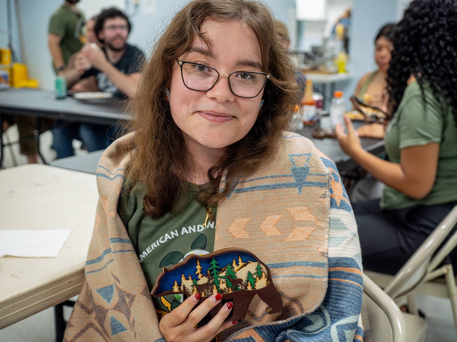 Kaitlyn McCarthy (Ramapough citizen, Field School & Wisconsin trip participant, and 2026 MSU grad) is honored with a blanket from Precious Benally on behalf of the NJ Center for Indigenous Justice