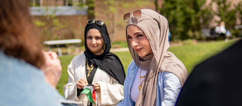 Students gather outside on campus.