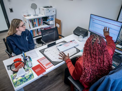 Advisor Helping Student at a desk
