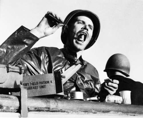 black and white photo of soldiers eating field rations