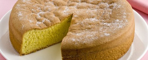 photo of an Italian sponge cake with a triangle slice cut out
