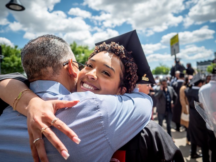 Graduate hugs her family member