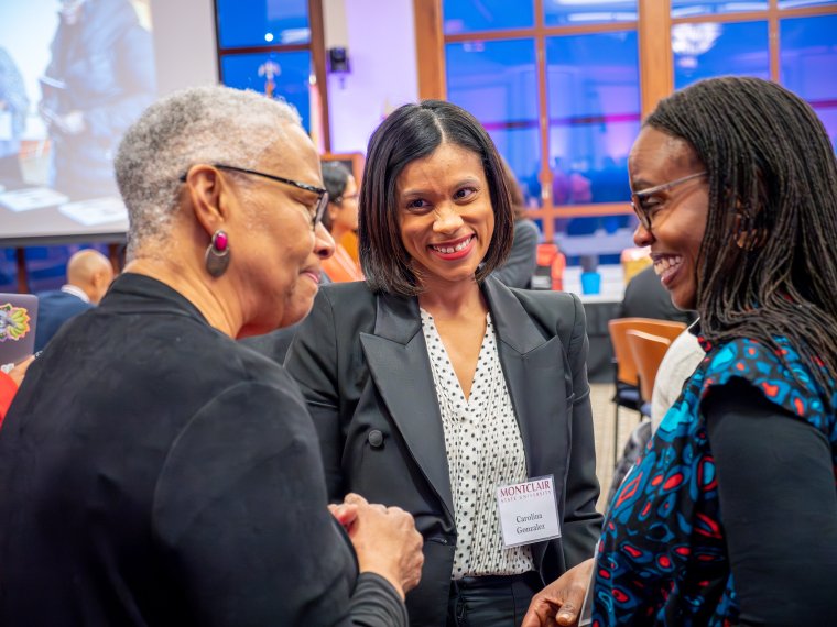three women chat at the Evening of Gratitude