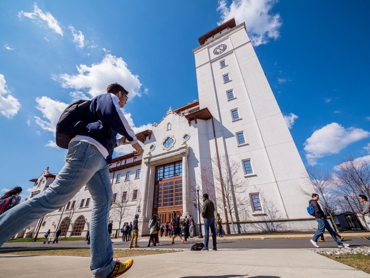 low angle view of University Hall with student walking in foreground