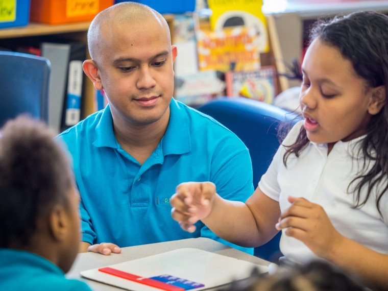 a teacher helps his students