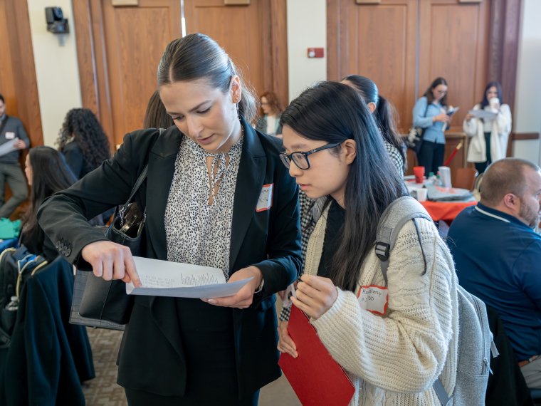 a Staff member helps a student during the Educators Exchange career fair