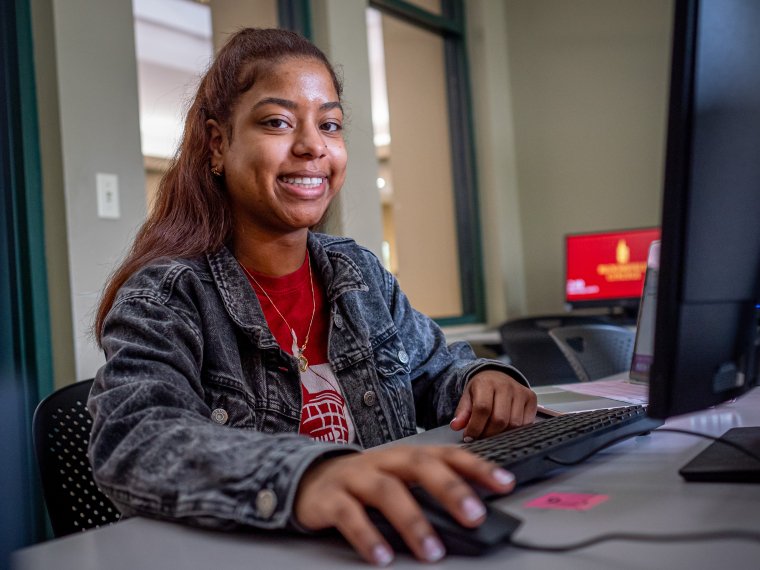 Woman smiling at computer desk