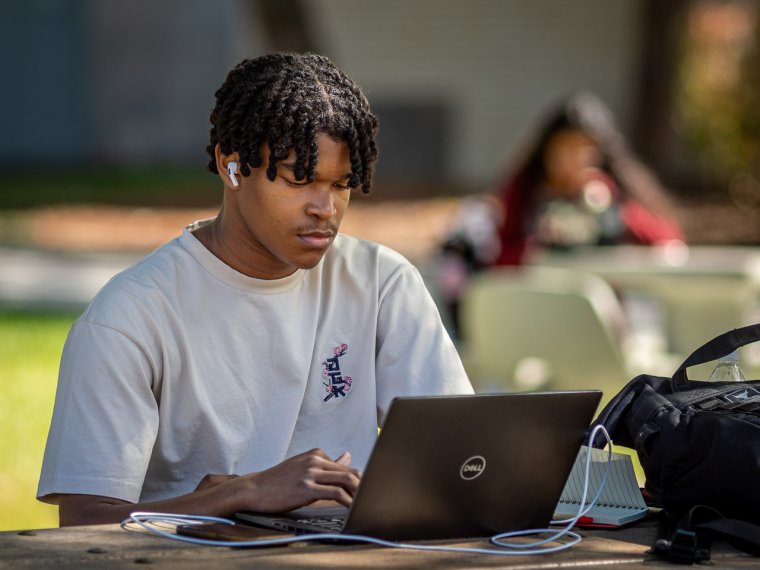 a student does work on his laptop
