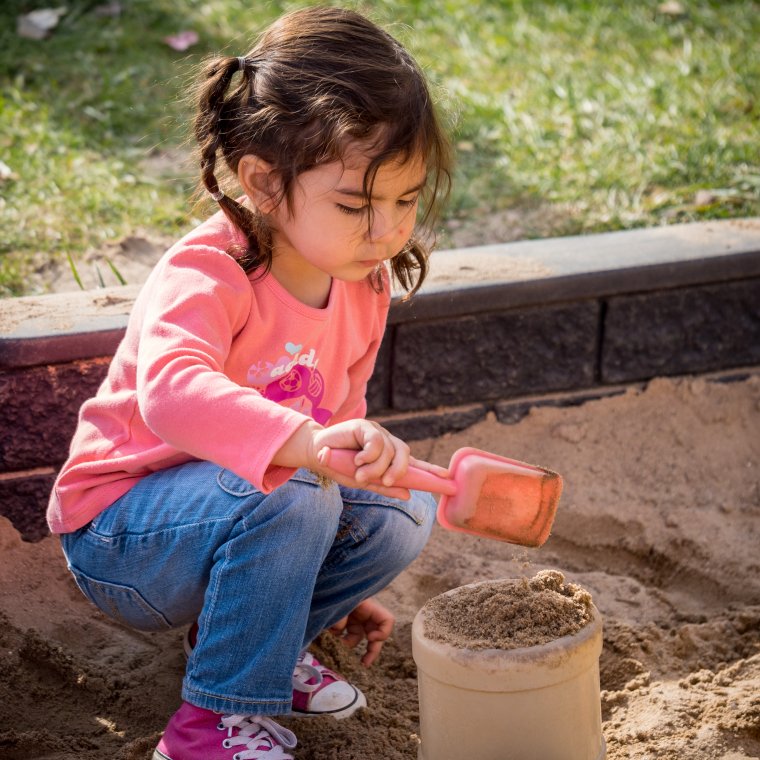 a child plays in the sandbox