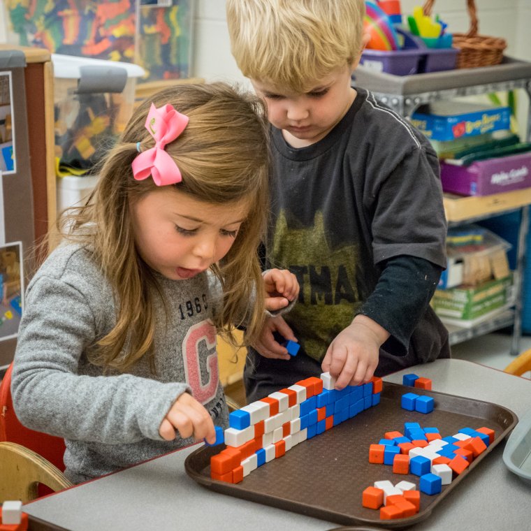two students play with blocks