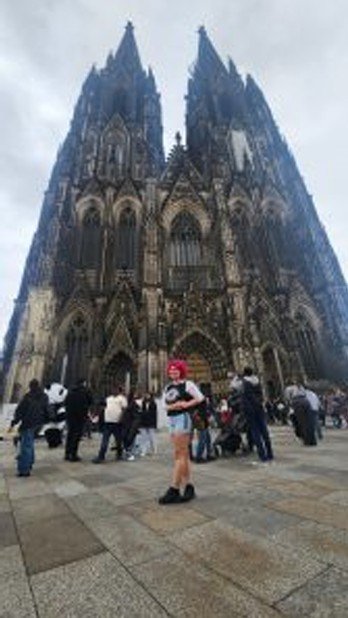 Avelisse Guzman poses in front of a medieval European church